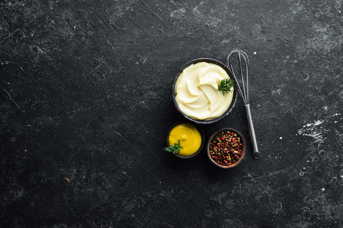 cooking-mayonnaise-sauce-oil-mustard-eggs-culinary-black-stone-background-top-view-min
