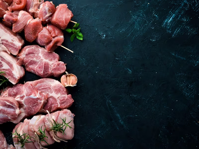 raw-meat-barbecue-meat-with-spices-herbs-black-stone-background-top-view-free-copy-space-min