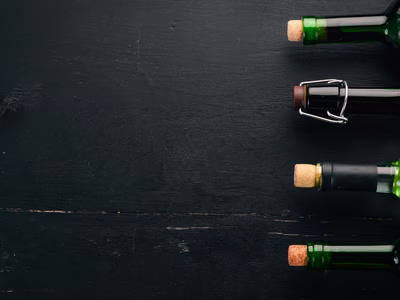 set-red-white-wine-bottles-glasses-grape-black-wooden-background-free-space-text-top-view-min